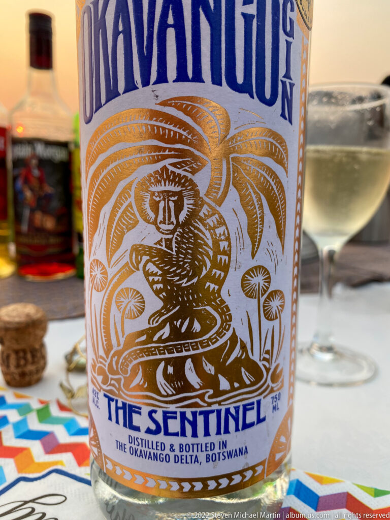 Close view of The Sentinel bottle label with cobra illustration and text stating it was bottled in the Okavango Delta, Botswana.