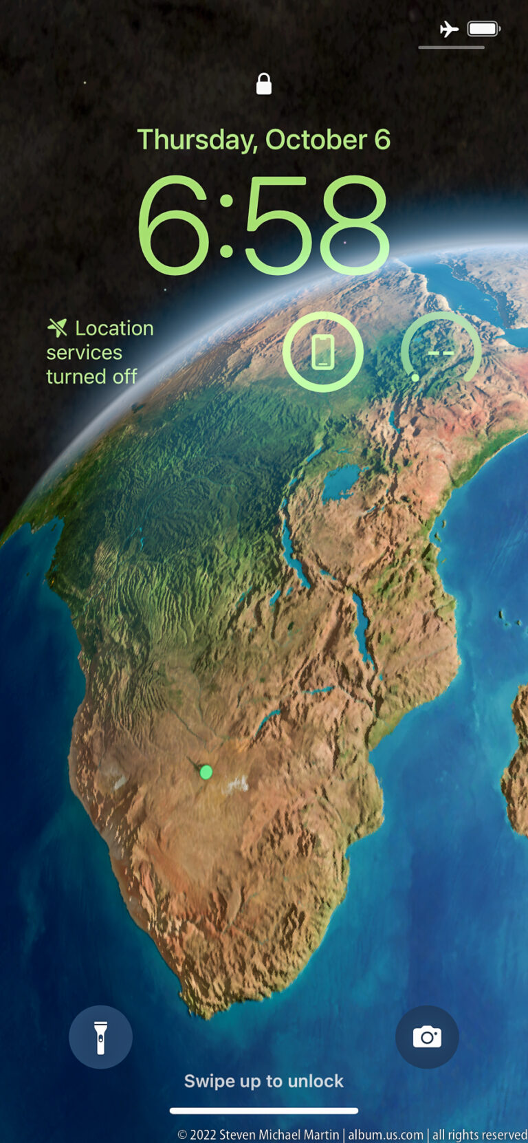Smartphone lock screen showing Thursday, October 6, the time, and a map centered on southern Africa.