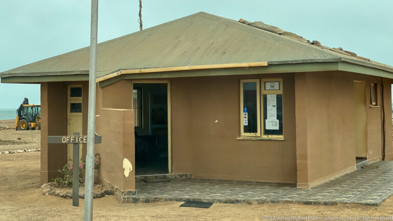 Single-story Cape Cross Seal Reserve office building with a hipped roof and an OFFICE sign near the entrance.