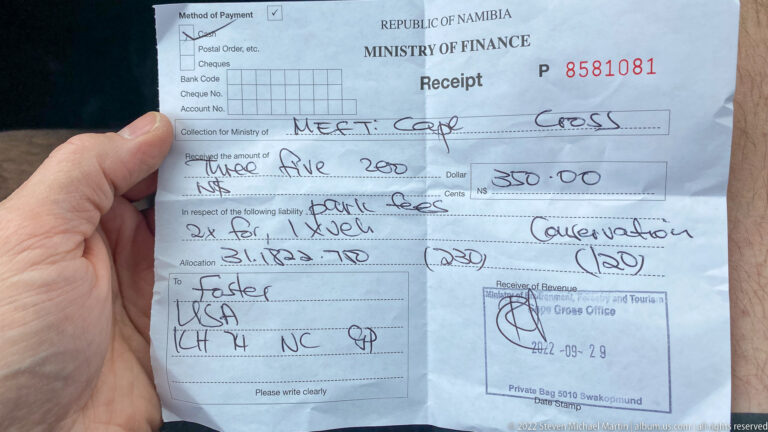 Close-up of a Republic of Namibia Ministry of Finance receipt showing N$350.00 paid in visitor and conservation fees for Cape Cross, dated 29 September 2022, held in a hand.