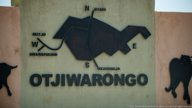 Wall sign reading OTJIWARONGO with directional labels for Otavi, Okahandja, Outjo and Swakopmund.