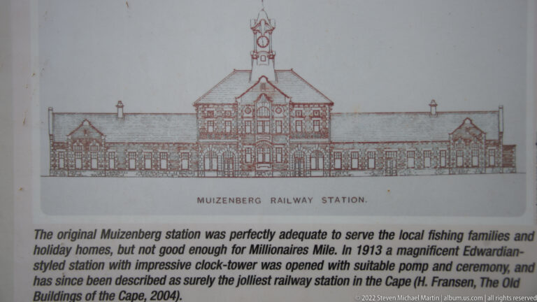 Interpretive panel with an elevation drawing labeled Muizenberg Railway Station and text describing the historic station.