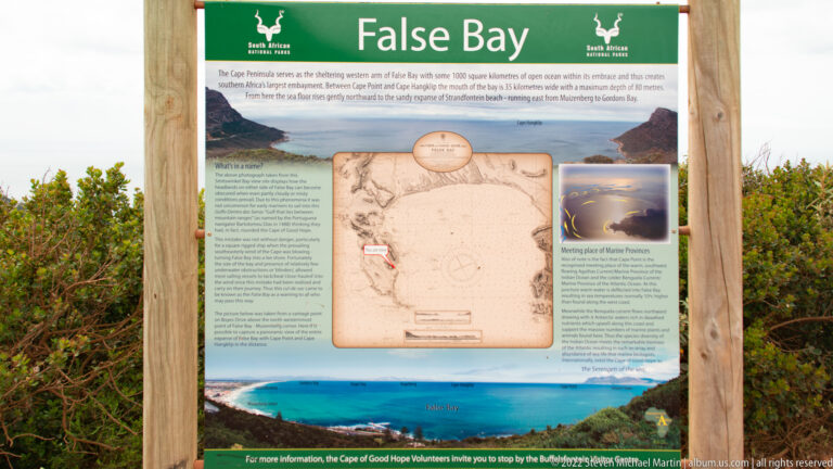 Outdoor interpretive panel titled “False Bay” with maps, historic graphics, photographs, and explanatory text.