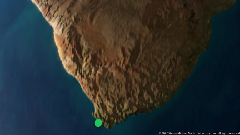 Satellite-style digital map of the Cape Peninsula surrounded by blue ocean, with a green location marker near the southern tip.