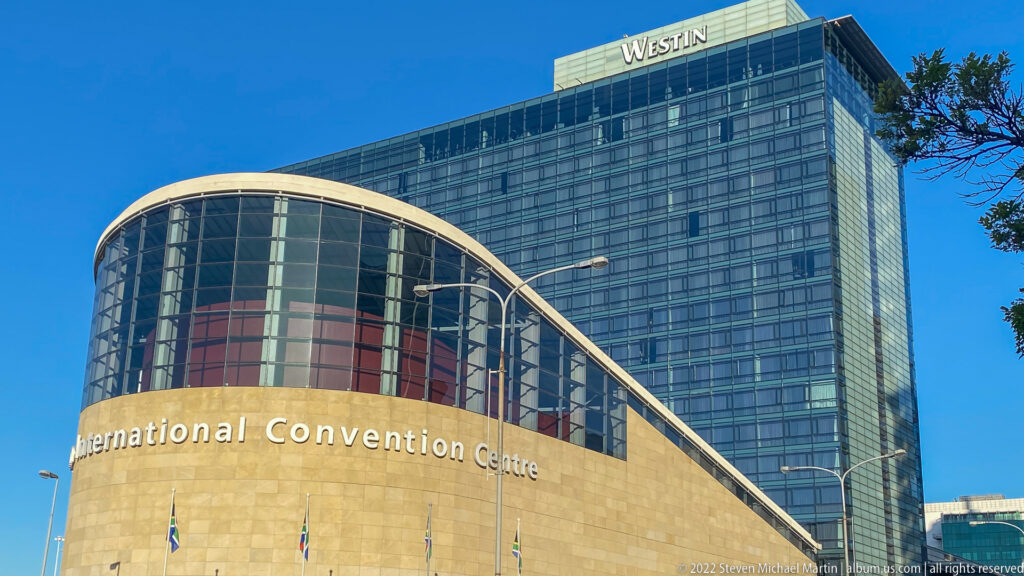 Curved Cape Town International Convention Centre façade in front of the glass Westin hotel tower.
