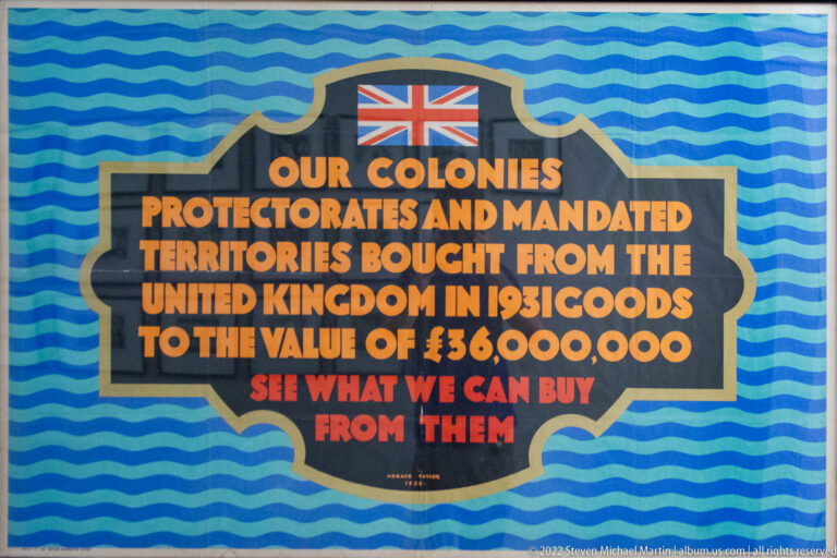 Blue interpretive panel with Union Jack and text about £136,000,000 in colonial purchases from the United Kingdom in 1913.