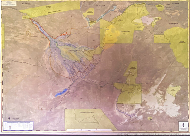 Large wall map of the Okavango region with colored reserve and concession areas, waterways, roads, and boundaries.