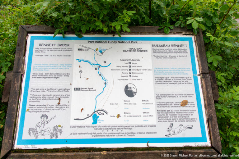 Bilingual Bennett Brook trail information panel with route map and illustrations in Fundy National Park.