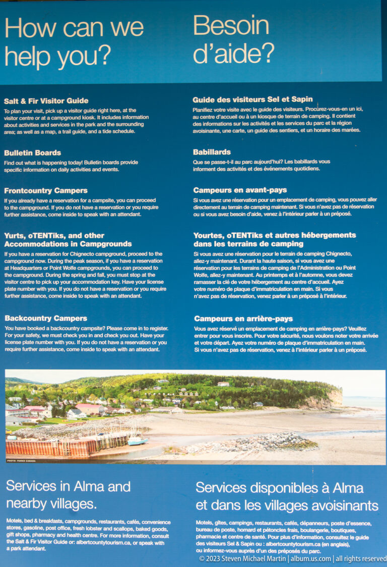 Blue bilingual visitor-information panel with safety guidance and a section on services in Alma and nearby villages.