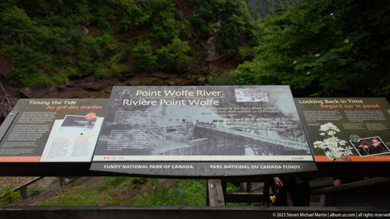 Fundy National Park interpretive panel titled Point Wolfe River with historic photographs and bilingual text.