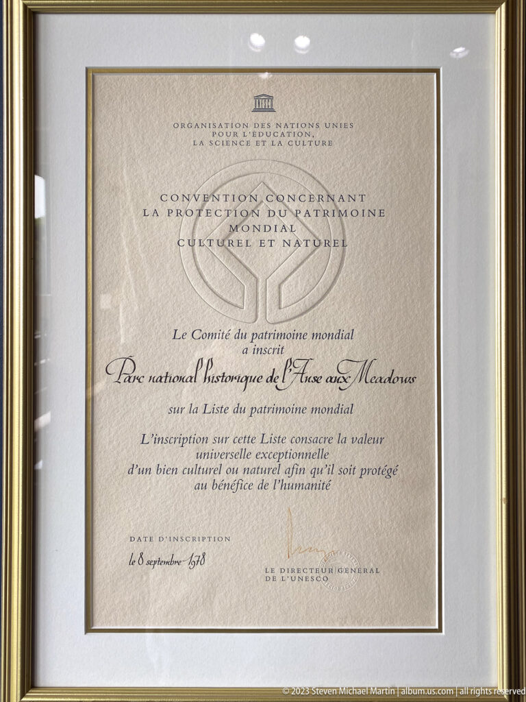 Framed French UNESCO World Heritage certificate for L’Anse aux Meadows with World Heritage emblem and inscription text.
