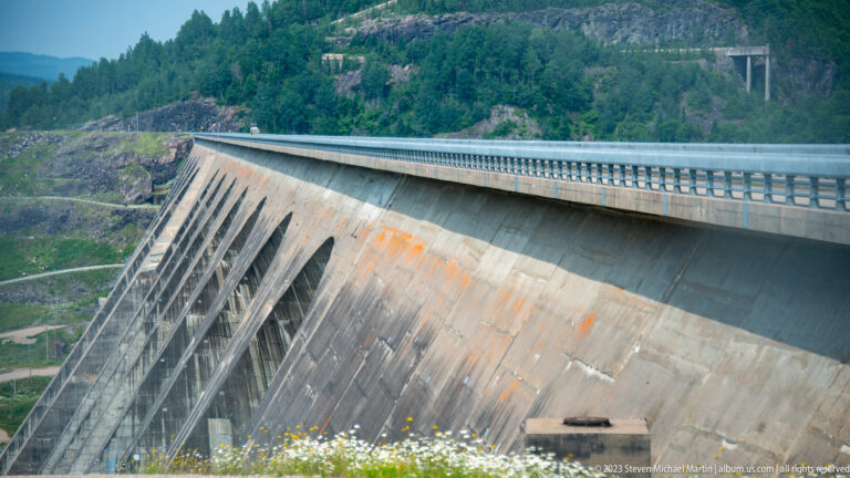 Oblique view along the massive multiple-arch concrete face of Daniel-Johnson Dam at Manic-5.