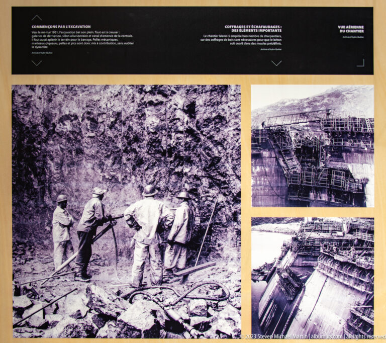 Interpretive panel with archival photographs of workers, scaffolding, and concrete formwork during Manic-5 construction.