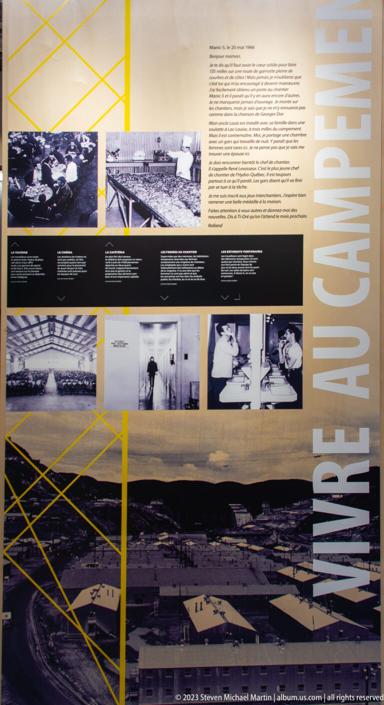Large French exhibit titled “Vivre au campement” with archival photographs and an aerial view of the Manic-5 construction camp.