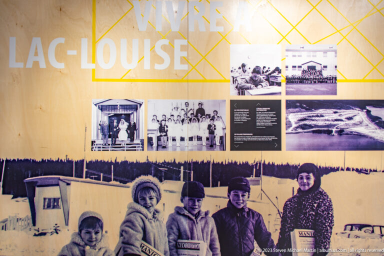 Historical exhibit on Lac Louise with archival photographs of children, families, and camp buildings in winter.