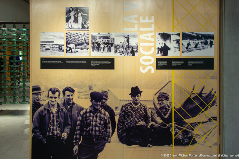 French social-history panel with archival group photographs and a large image of Manic-5 camp residents.