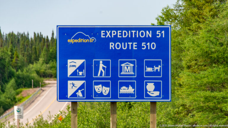 Blue 'EXPEDITION 51 — ROUTE 510' sign with pictograms for attractions, hiking, museums, boating, ferry travel, and food.