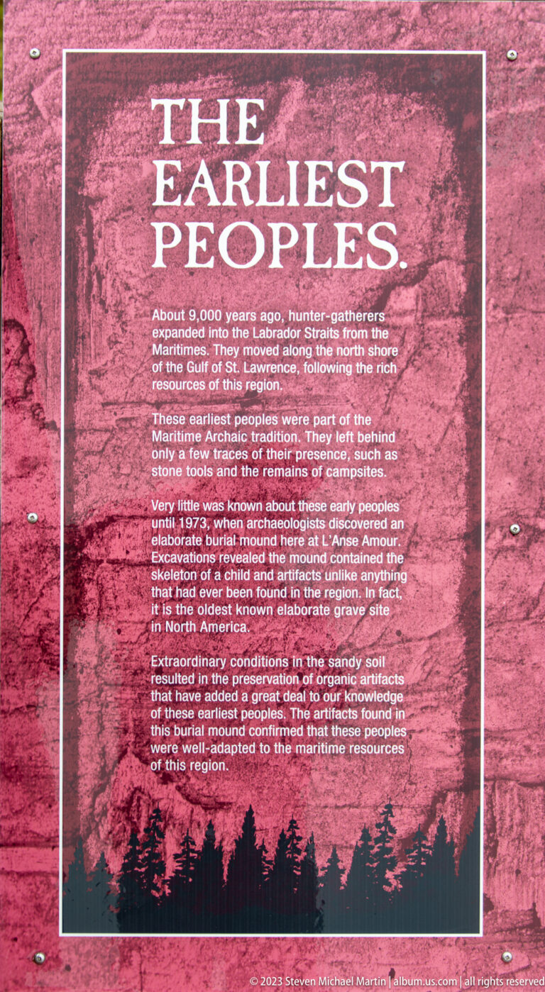 Red interpretive panel titled 'The Earliest Peoples' with white text and a dark tree silhouette along the bottom.