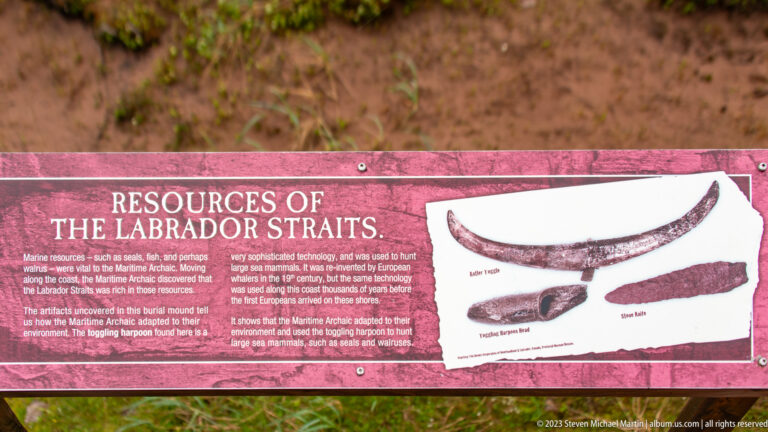Red interpretive panel titled 'Resources of the Labrador Straits' with illustrations of worked implements.