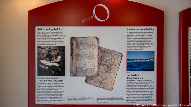 Bilingual museum panel titled 'Rediscovering Red Bay' with archival documents, photographs, and explanatory text.