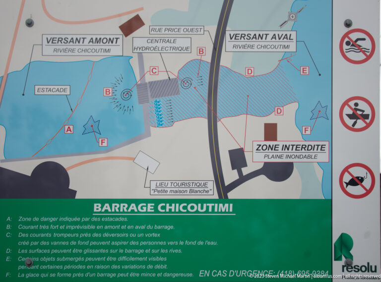 Barrage Chicoutimi safety map showing the hydroelectric plant, river, floodplain, hazard zones, and prohibition symbols.