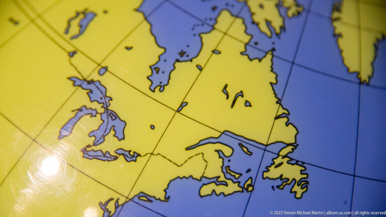Close-up of a yellow-and-blue map showing northeastern North America and the North Atlantic region.