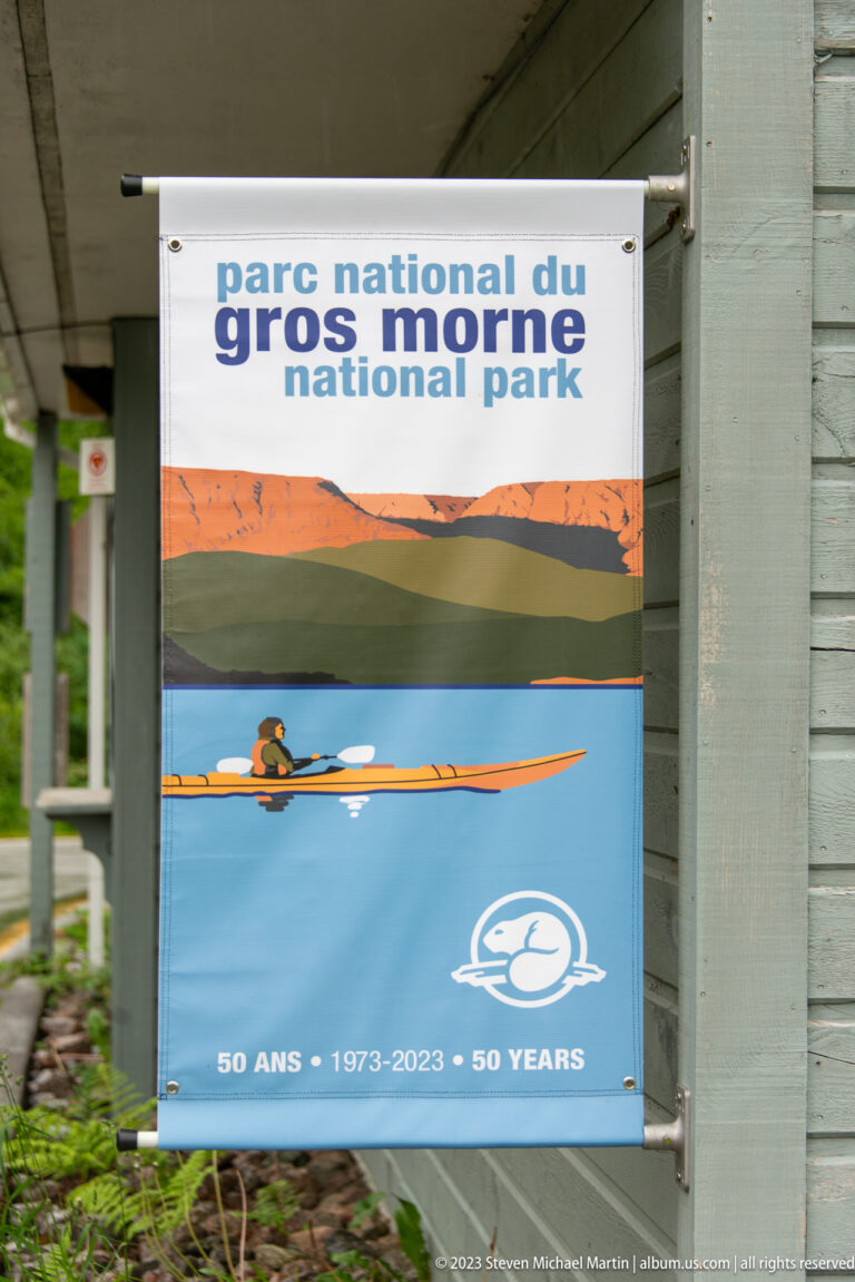 Bilingual Gros Morne National Park poster showing a kayaker and ‘50 years 1973–2023’ text.