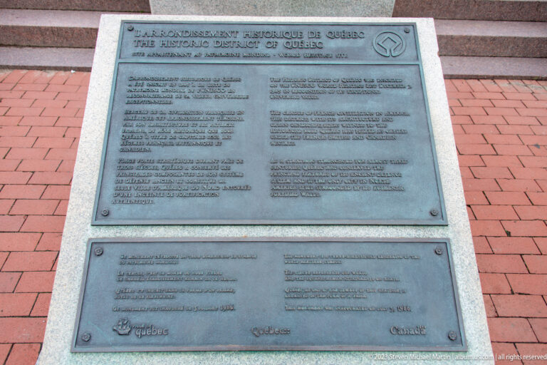 Bronze bilingual World Heritage plaque for the Historic District of Québec mounted in granite paving.