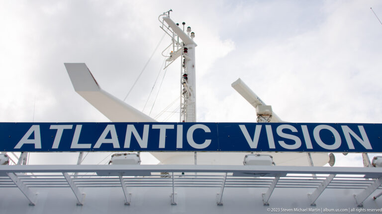 Blue ATLANTIC VISION nameboard stretches across the ferry's upper structure below mast and antenna equipment.