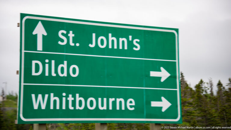 Green road sign points straight to St. John’s and right to Dildo and Whitbourne.