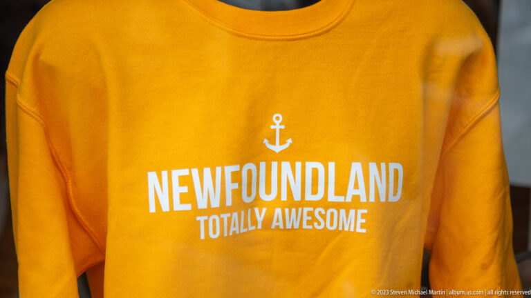 Orange sweatshirt printed with a white anchor and the words “Newfoundland Totally Awesome.”