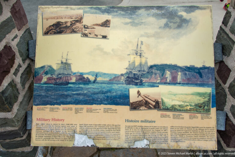 Signal Hill interpretive panel titled Military History with paintings of ships, fortifications, and historic military scenes.