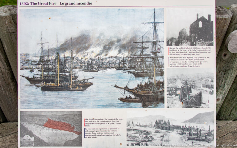 Interpretive panel about the Great Fire of 1892 with a large harbor illustration, smoke, ships, maps, and historic photographs.