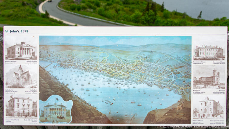 Interpretive panel labeled St. John’s, 1879 with a bird’s-eye harbor panorama and small drawings of historic buildings.