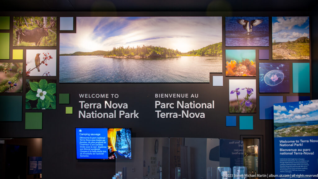 Multimedia Terra Nova National Park welcome wall with landscape, wildlife photographs, and digital screens.