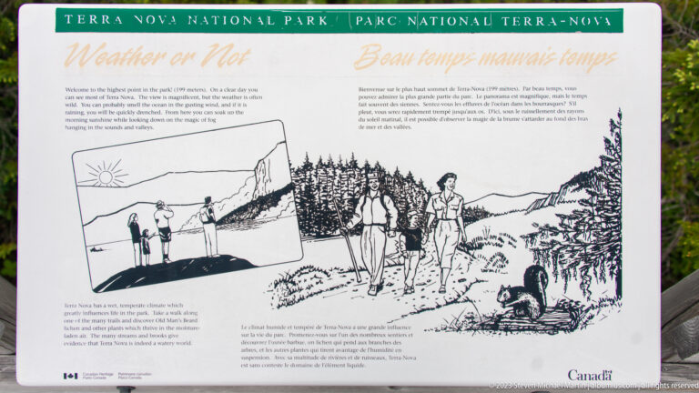 Bilingual weather interpretive panel with drawings of hikers on exposed coast and wooded trail in contrasting conditions.