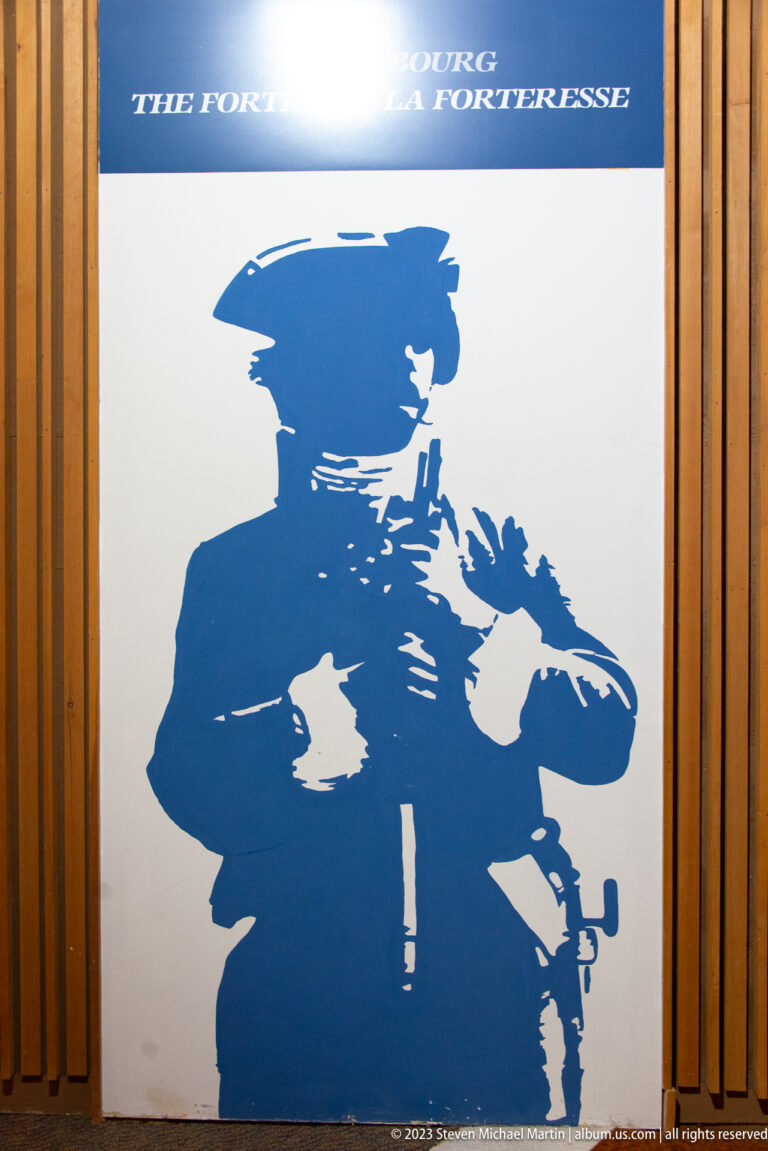 Blue graphic silhouette of an eighteenth-century soldier on a white interpretive panel.