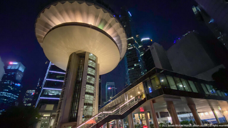 Extreme low-angle view of the Supreme Court of Singapore with its illuminated circular roof.