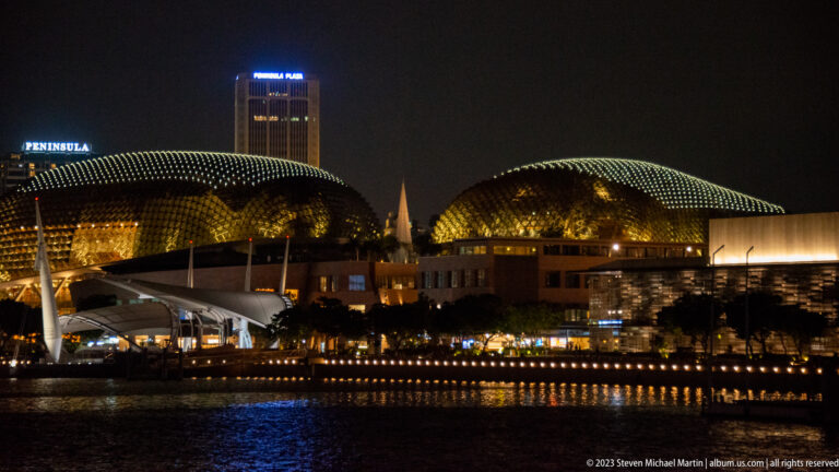 Illuminated twin domes of Esplanade – Theatres on the Bay across the water at night.