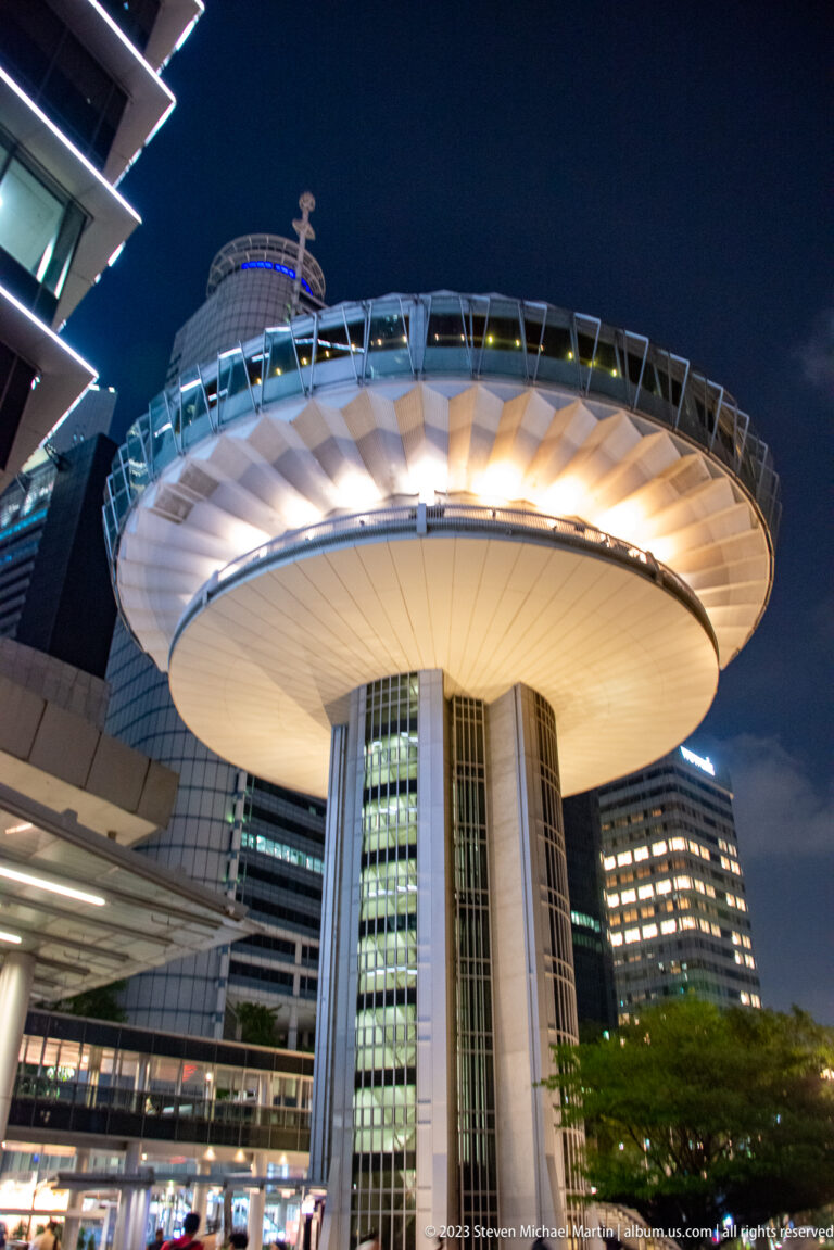 Low-angle view of the Supreme Court of Singapore with a large illuminated circular roof.