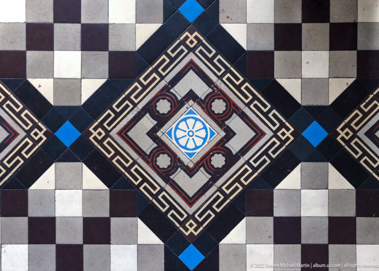 Geometric historic floor tiles with checkerboard pattern.