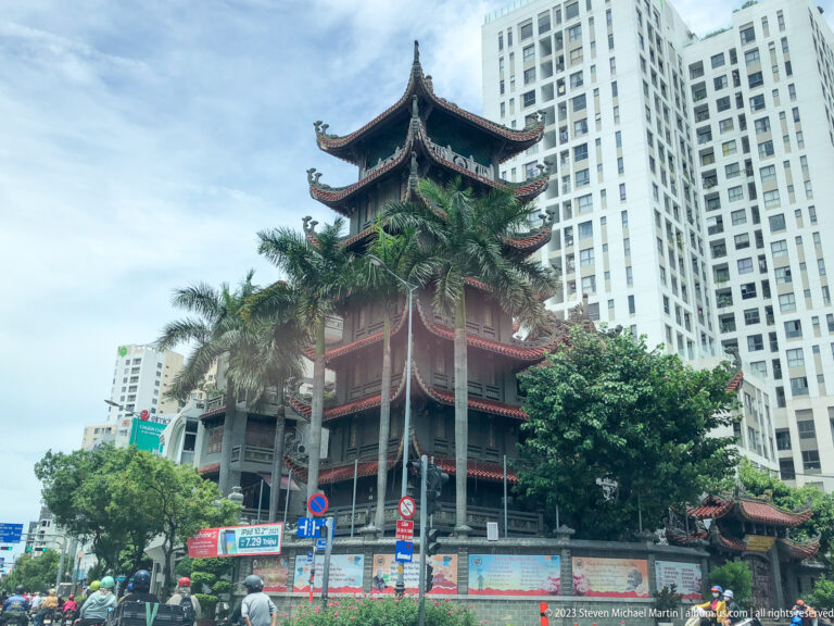 Traditional pagoda beside modern high-rises.