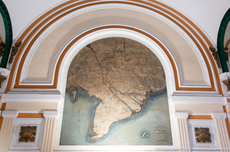 Large historical map of southern Vietnam and nearby regions mounted within an arched cream-and-orange wall panel.