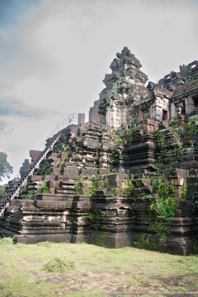 Oblique close view of mossy stepped temple masonry at Angkor Thom.