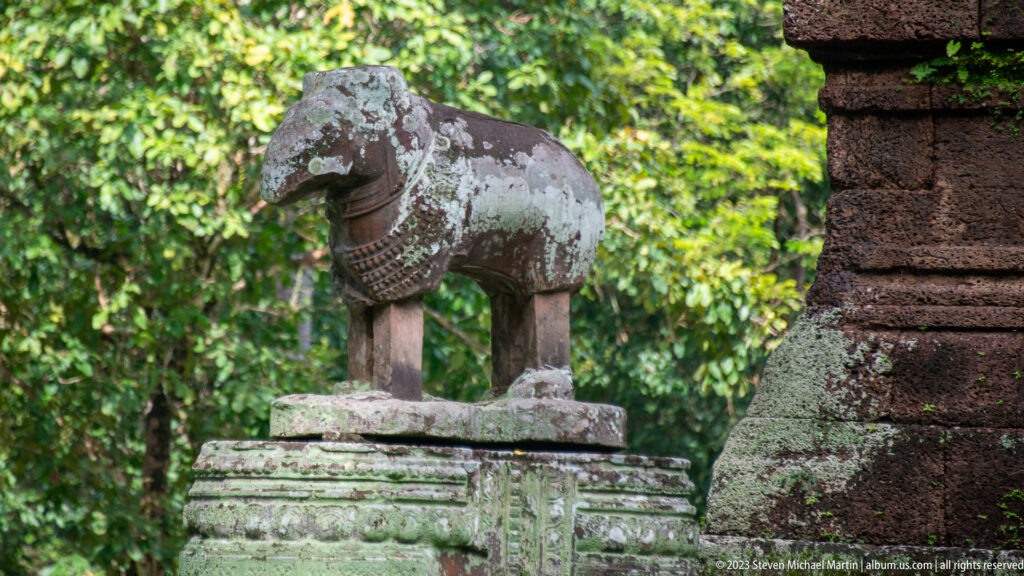 Stone guardian animal standing on a square pedestal at Angkor Thom.