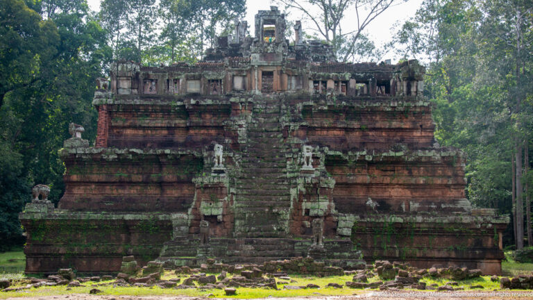 Straight-on view of a narrow stair in a low layered terrace at Angkor Thom.