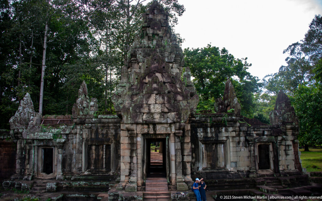 Frontal temple gateway with tall central tower and side galleries at Angkor Thom.
