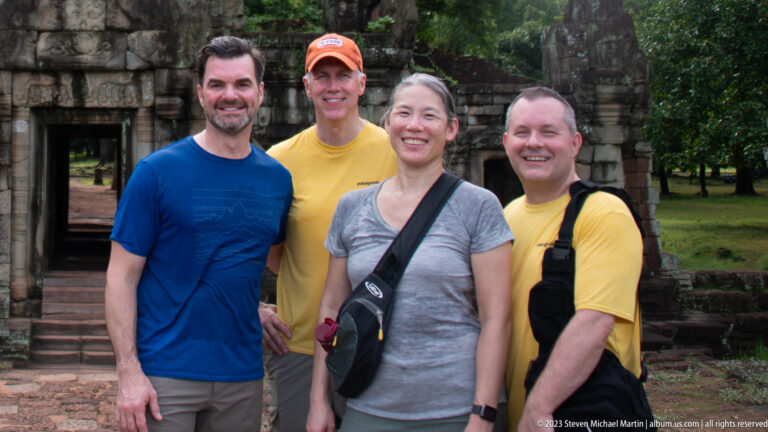 Tighter group portrait of four visitors at Angkor Thom.
