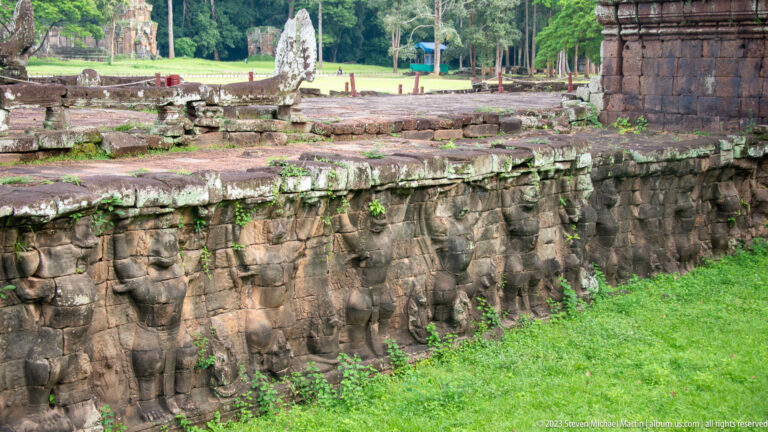 Longer view of repeating elephants along a terrace wall at Angkor Thom.