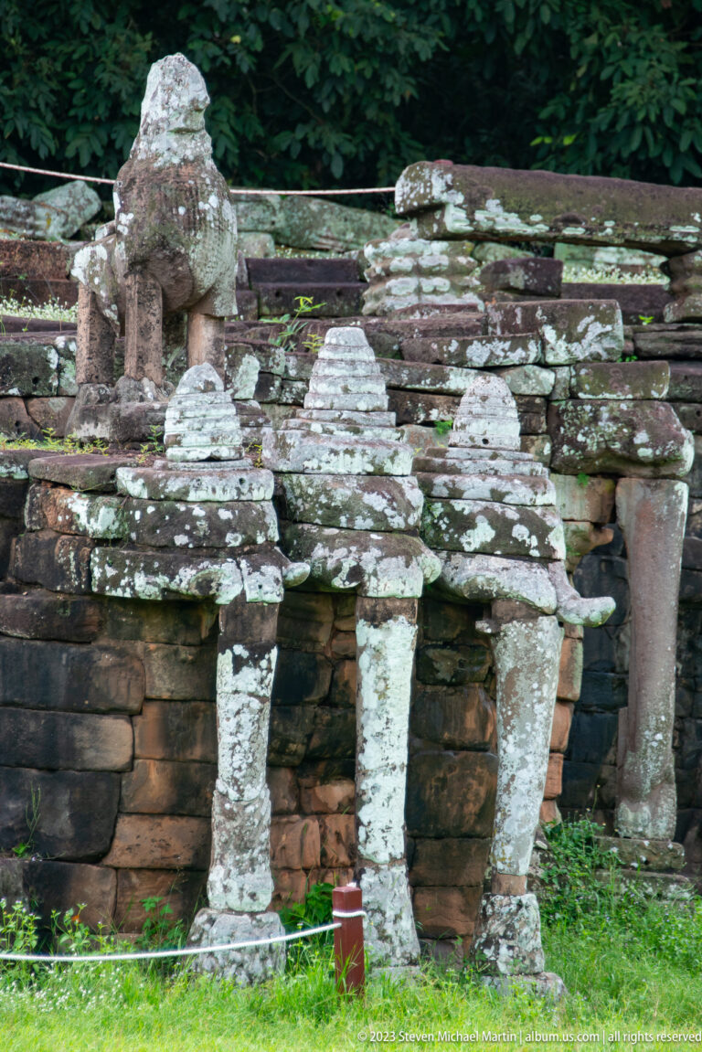 Three small towered niches supported by narrow columns at Angkor Thom.